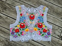 Famous Kalocsa handembroidered vest with authentic Hungarian pattern. High quality hand-embroidered work with lot of work Bust :40 - 41 inch Lenght : 18 " Hand washes only. If you are buying several pieces I can combine postage at the time of mailing. If you have any question please don't hesitate to contact me,  My Etsy shop: https://www.etsy.com/shop/TreasuryCoffer Folk Style Floral Embroidered Vest For Spring, Folk Style Embroidered Vest For Spring, Embroidered Folk Vest For Spring, Folk Style Embroidered Spring Vest, Spring Embroidered Multicolor Vest, Embroidered Multicolor Spring Vest, Multicolor Embroidered Vest For Spring, Spring Multicolor Embroidered Vest, Folk Style Embroidered Vest