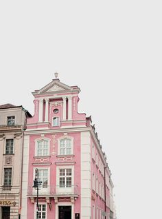 a pink and white building with a clock tower