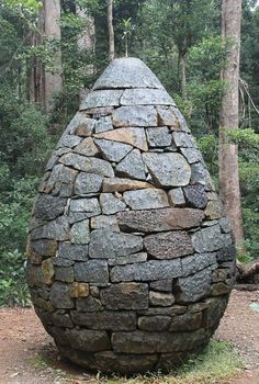 a large stone structure in the middle of a forest