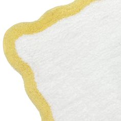 a close up of a yellow and white rug