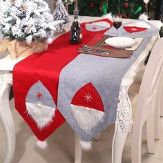 a christmas table setting with santa claus decorations