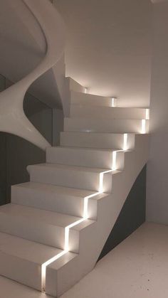 a white staircase with lights going down it's sides and the top part is lit up