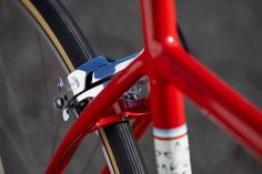 the front brake of a red bicycle