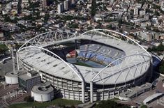 an aerial view of a soccer stadium in the middle of a city with lots of tall buildings