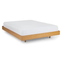 the bed frame is made from wood and has white sheets