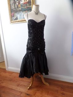 This dress rocks a bustier style top, with tight fitted bodice, handkerchief ham with lots of crinoline in the back to create fullness. Steampunk, rocker, retro glam...fabulous! Size 6 Sequin Bustier, Rock Dresses, Retro Glam, Black Sequins, Fitted Bodice, Style Dress, Vintage Black, Rocker, Sleeveless Formal Dress