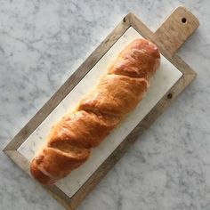 a loaf of bread sitting on top of a cutting board