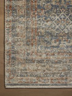 an area rug with various colors and patterns on it, including blue, red, beige, and orange