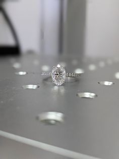 a diamond ring sitting on top of a table