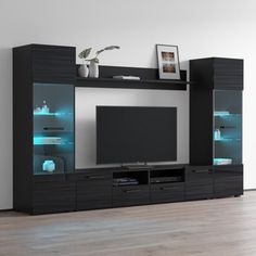 a black entertainment center with glass doors and shelves on the side, in front of a white wall