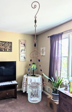 a glass jar hanging from a ceiling in a living room