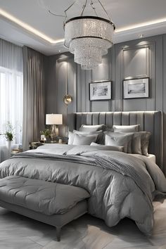 a large bed sitting under a chandelier in a bedroom next to a window