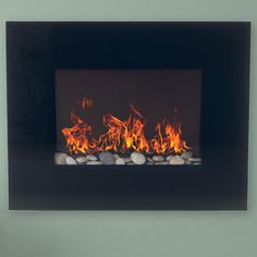 a fire burning in a fireplace with rocks on the bottom and red flames coming from it