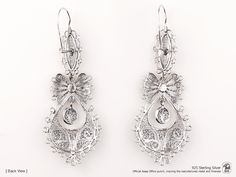 "Original Portuguese Filigree QUEEN Heart Earrings, Fashion Folk - Traditional Filigree Jewelry from Viana, Portugal - Brand-new (Unused). Very elegant and exclusive earrings, handmade by experienced Artisans and manufactured in 925 Sterling Silver. Item specifics: Model: Queen EARRINGS Reference: JM-BR002 Backing type: hook Material: 925 Sterling Silver Height: aprox. 6.5 cm (with hook) Weight: aprox. 7,5 grams Condition: Brand-new (Unused) Original Portuguese Traditional Filigree Jewelry - Han Silver Diamond Earrings With Intricate Design For Wedding, Elegant Silver Diamond Earrings With Intricate Design, Ornate Filigree Earrings For Anniversary, Ornate Filigree Bridal Earrings For Formal Occasions, Evening Jewelry In Sterling Silver With Intricate Design, Intricate Dangle Diamond Earrings For Anniversary, Oval Filigree Earrings For Wedding, Intricate Design Diamond Dangle Earrings For Anniversary, Formal Silver Diamond Earrings With Intricate Design