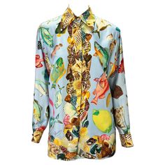 Presenting a baby blue aquatic motif silk button-down Gucci shirt. From the Spring/Summer 1992 collection, this fabulous top appeared on the season's runway and in the season's ad campaign. Covered in shells and different aquatic life, this fabulous shirt is made complete with gold 'GG' Gucci buttons at the neck and cuffs. Approximate measurements: Size - IT38 22.5" shoulder to cuff 19.5" underarm to cuff 28" shoulder to hem 41" bust 41" waist 100% silk Luxury Fitted Gucci Blouse, Elegant Gucci Button-up Blouse, Summer Fitted Gucci Tops, Gucci Fitted Tops For Spring, Fitted Gucci Tops For Spring, Designer Silk Tops With Buttons, Gucci Button-up Shirt For Spring, Luxury Long Sleeve Summer Shirt, Gucci Fitted Blouse For Spring