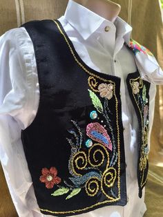 Festive Vest With Multicolor Embroidery, Festive Embroidered Vest With Multicolor Embroidery, Festive Embroidered Multicolored Vest, Bohemian Black Embroidered Vest, Folk Style Festive Vest With Floral Embroidery, Festive Folk Vest With Floral Embroidery, Bohemian Fitted Vest With Multicolor Embroidery, Fitted Bohemian Vest With Multicolor Embroidery, Black Folk Style Festival Vest