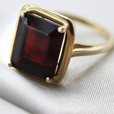 An Absolutely gorgeous Red Garnet Gold ring. Featuring a Prong set 6.5 Carat 10 x 12 Red Garnet natural Gemstone. The color is simply amazing as well as the clarity, This is a Grade AAA corundum Gemstone. When i saw the beauty of this gemstone i had to have it, I simply had to buy a few and make a few rings with them i could not escape its beauty! Each ring is hand made to your order from start to finish with the utmost attention to details, service and finish. We only have a few of these marvel Classic Rings With Garnet And Prong Setting, Classic Garnet Rings With Prong Setting, Classic Garnet Solitaire Rings, Classic Solitaire Garnet Ring, Fine Jewelry Garnet Solitaire Ring, Classic Ruby Solitaire Rings, Classic Ruby Gemstones With Prong Setting, Garnet Emerald Cut Promise Ring, Classic Red Birthstone Ring With Prong Setting