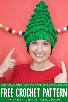 a woman wearing a green knitted christmas tree hat and giving the thumbs up sign