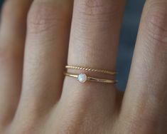 Handmade 3mm white opal 14k gold filled band ring✨🌚 Dainty and perfect minimalist piece! Stunning 3mm lab grown opal gemstones. Each stone is hand set into a bezel and polished for a beautiful shine finish. Opal means jewel. The energies of this stone will also encourage you to express your true self, in addition to feeling confident and comfortable in your own skin, and this will radiate in your words, thoughts, and actions. Material: 14/20 (karat/purity) gold filled Or solid 925 Sterling silv Gold Stackable Opal Ring For Everyday, Everyday Gold Stackable Opal Ring, Gold Opal Stackable Ring For Everyday Wear, Gold Dainty Opal Ring Birthstone, Dainty Gold Opal Ring Birthstone, Minimalist Gold Opal Rings, Minimalist Yellow Gold Opal Ring, Minimalist Opal Stackable Promise Rings, Dainty White Opal Ring In 14k Gold