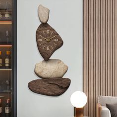 a clock made out of rocks sitting on top of a table next to a lamp