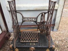 an old sewing machine sitting in the dirt