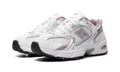 the new balance 997 running shoe in white with pink accents on the upper part