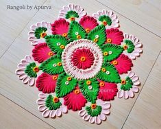 rangdi work on the floor with flowers and leaves in pink, green and white colors