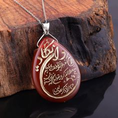 The pendant is handmade and has an Islamic Nazar Dua design, and is made of natural agate and silver chain.  Agate stone is a popular natural stone that has many benefits for the human soul, including its ability to fight against stress and negative energy. This beautiful stone comes in various colors such as blue, white, green, pink, red, and brown, and is widely used in jewelry and accessory products designed for both men and women. One such product is the Engraved Nazar Evil Eye Pendant Neckl Traditional Teardrop Necklace For Gift, Amulet Style Agate Necklace For Gift, Agate Amulet Necklace For Gift, Agate Pendant Necklace For Gifts, Agate Pendant Necklace Gift, Spiritual Agate Necklaces As Gifts, Spiritual Agate Necklace Gift, Spiritual Agate Necklace For Gift, Brown Agate Jewelry For Gifts