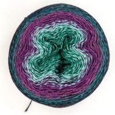 a ball of yarn with green, purple and white stripes on it's end