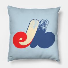 a blue pillow with red, white and blue waves on it's side in front of a light blue background