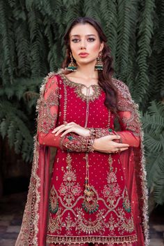 Royal Pakistani Bridal Outfit in Gharara Kameez Style is a traditional attire adorned with hand-crafted details of embellishments. Premium quality of the fabric and perfect stitching make this beautiful Gharara Dress an epitome of beauty and tradition. Bridal Kameez: The kameez in an alluring red shade is intricately adorned with embroidery, naqshi, and tilla. Hand-crafted details of Sitara and sequins give a glamorous touch to this perfectly stitched kameez in premium organza, making it a perfe Bollywood Naqshi Dress For Traditional Ceremonies, Bollywood Style Dress With Naqshi For Traditional Ceremonies, Wedding Salwar Kameez With Naqshi Detail, Floor-length Salwar Kameez With Naqshi For Weddings, Eid Naqshi Floor-length Lehenga, Semi-stitched Chinon Sharara With Naqshi, Bollywood Style Sharara With Naqshi, Bollywood Style Sharara With Naqshi Detail, Bollywood Style Intricate Embroidery Lehenga