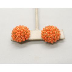 This is part of Chairish’s Costume Jewelry assortment.  1960s round goldtone pave cabochon pale orange faux-coral studded domed clip earrings. Marked "Hobe." Measure: 7/8 inches across by 1/2 inch deep. Condition: Very good; some yellowing to plastic rollers on the backs normal for their age. Elegant Orange Clip-on Earrings, Vintage Orange Round Earrings, Orange Clip-on Earrings For Formal Occasions, Formal Orange Clip-on Earrings, Vintage Orange Beaded Earrings, Orange Beaded Vintage Earrings, 50s Costume, Pale Orange, Coral Beads