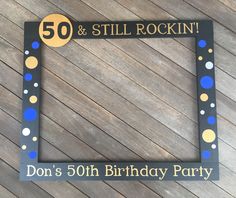 a 50th birthday party photo frame with the number 50 and still rockin'on it