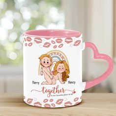 a pink and white coffee mug with two women on it, one is holding the other's hand