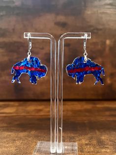 These cute and unique earrings are the perfect accessory to turn heads while cheering on your beloved Buffalo Bills!  Made with lightweight resin for comfortable wear and no heavy pulling. Earring hooks are stainless steel, nickel-free, and hypoallergenic so they are safe for sensitive ears.  Wear them all day without any discomfort. Each pair of earrings is handmade to order with love, therefore no two pairs are identical, but I do try to get as close as possible :)  Small imperfections and sli Bills Mafia, Fan Earrings, Sparkly Earrings, Fan Girl, Christmas Deals, Buffalo Bills, Earring Hooks, Sensitive Ears, Unique Earrings