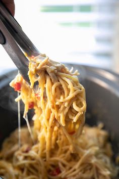 a person is eating spaghetti with chopsticks