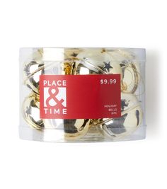 a plastic container filled with gold and white buttons