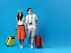 young man and woman with suitcases on blue background stock photo ©ourphotor