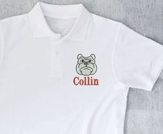 Polo style shirt with embroidery design Classic Embroidered Polo Collar Top, Classic Embroidered Tops With Polo Collar, Casual Embroidered Cotton Polo Shirt, Casual Cotton Embroidered Polo Shirt, White Tops With Custom Embroidery For School Spirit, White Tops With Letter Embroidery For School, White Letter Embroidery Top For School, White Embroidered Letter Top For School, Embroidered Cotton Polo Shirt