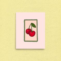 two cherries on a pink background with green trim around the edges are framed by small dots