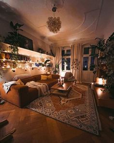 a living room filled with furniture and lots of plants on the wall next to a window