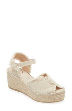 A woven platform and wedge heel underscore the espadrille-inspired style of this summery sandal finished with frayed trim. 2 1/2" heel, 1 1/2" platform (size 39w) Textile upper/synthetic lining and sole Made in Spain Cream Wedge Heel Espadrilles For Spring, Cream Straw Espadrilles For Spring, Spring Cream Straw Espadrilles, Cream Espadrille Sandals For Vacation, Chic Open Toe Cream Espadrilles, Chic Cream Open Toe Espadrilles, Cream Wedge Heel Espadrilles For Summer, Chic Cream Espadrille Wedge Sandals, Cream Wedge Heel Espadrilles In Straw