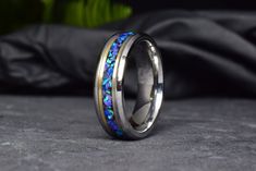 a wedding band with blue opal inlays