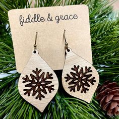 "Fiddle and Grace is proud to offer affordable, lightweight super cute earrings! Need something to add to all your festive Christmas outfits? This pair of adorable, lightweight earrings is the perfect touch! They measure 1.8\" wide x 1.8\" tall and 1/8 inch thick. The ones in the listing photo are made of White Oak and custom laser cut with a Classic Silver Nickel Free French Hook Ball Earwire. We do finish our wood with a non-toxic sealer, this does not make them waterproof, however, since the Holiday Winter Drop Earrings, Winter Holiday Drop Earrings, Winter Festive Dangle Earrings, Snowflake Earrings For Winter Gift, Winter Snowflake Earrings For Gifts, Wood Burn Earrings, Xtool Projects, Festive Christmas Outfit, Yule Celebration