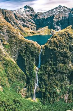 an aerial view of a waterfall in the mountains