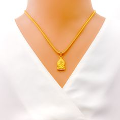 This attractive pendant, exquisitely crafted from 22k gold and weighing 3.2 grams, features a finely engraved depiction of Sai Baba set against a luminous yellow gold finish. The pendant has a length of 0.9 inches, making it both noticeable and modest in size, ideal for daily wear. Perfect for devotees who wish to keep Sai Baba close to their hearts, this pendant combines spiritual devotion with elegant craftsmanship, offering a timeless piece that embodies grace and serenity. PRODUCT DETAILS Gold Purity(karat): 22k Gold Weight(grams): 3.2 Item Finish: Yellow Gold Pendant Length: 0.9" Chain: Not Included Gold Plated Necklaces For Diwali Gift, Gold-plated Temple Necklace For Gifts, 22k Gold Necklaces For Puja, Spiritual Gold Plated Temple Necklace As Gift, 22k Gold Temple Jewelry Necklace As Gift, 22k Gold Locket Necklace In Temple Jewelry Style, Temple Jewelry Style Yellow Gold Necklace As Gift, 22k Gold Locket Temple Necklace, Temple Jewelry Yellow Gold Necklace Gift