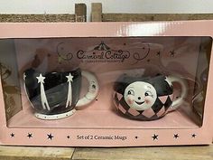 two ceramic mugs are in the box