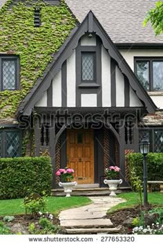 a large house with lots of windows and plants on the front