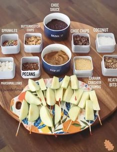 the ingredients for an apple pie laid out on a wooden board with their corresponding toppings