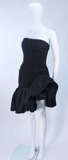 For Sale on 1stDibs - This Ungaro dress is composed of a fine black silk with a gathered detail throughout the bodice and a dramatic ruffle detail. There is a center back zipper Fitted Silk Evening Dress With Folds, Fitted Evening Dress With Folds, Black Fitted Evening Dress With Ruched Bodice, Draped Ruffles Evening Dress, Black Evening Dress With Ruched Back, Black Draped Fitted Evening Dress, Silk Evening Dress With Ruffles For Cocktail, Black Fitted Draped Evening Dress, Fitted Black Draped Evening Dress